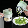 Handheld vegetable chopper with green vegetables on a plate against a black background