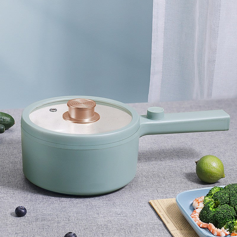Light blue pot with a white interior on a gray surface with vegetables around