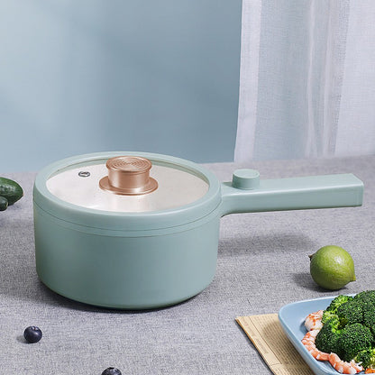 Light blue pot with a white interior on a gray surface with vegetables around