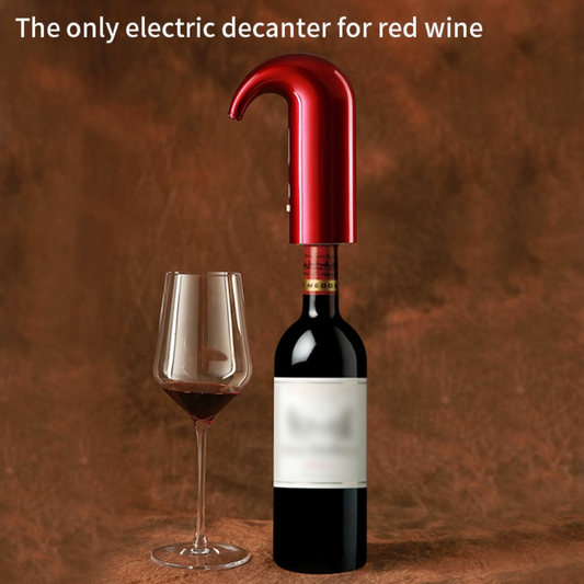 Red electric decanter next to a bottle of red wine and a glass on a brown background
